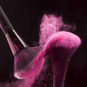 makeup-brushes-with-pink-powder-haze-min